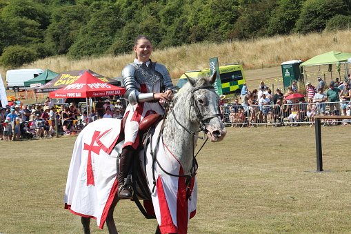 Waterlooville, UK - 14 August, 2022: A group of talented horse riders recreating a medieval jousting tournament at a show in Hampshire.