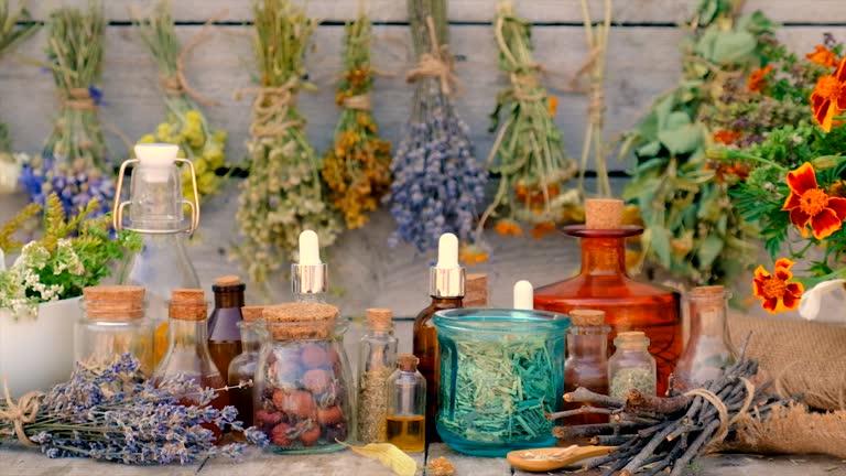 Tinctures and extracts of herbs in a jar. Selective focus. Nature.