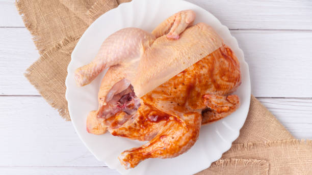 Fresh organic chicken on a half with marinade stock photo