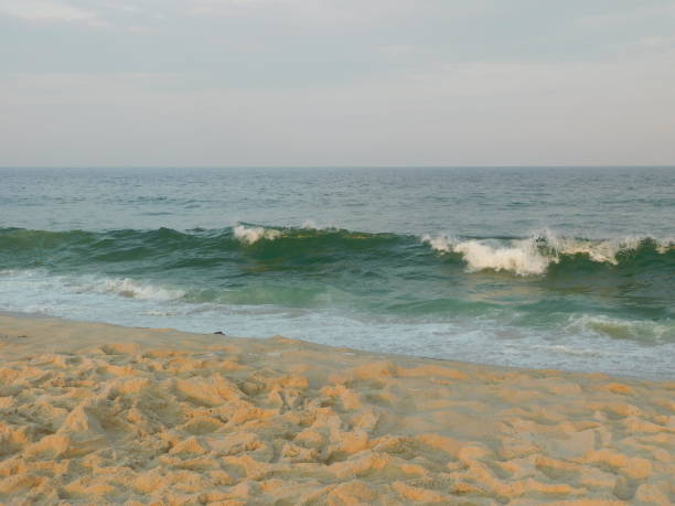 Rolling waves in seaside Park New Jersey. Aqua. Turquoise colored. Sand. Warm.