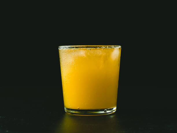 istock Citrus juice on dark background. 1422794183