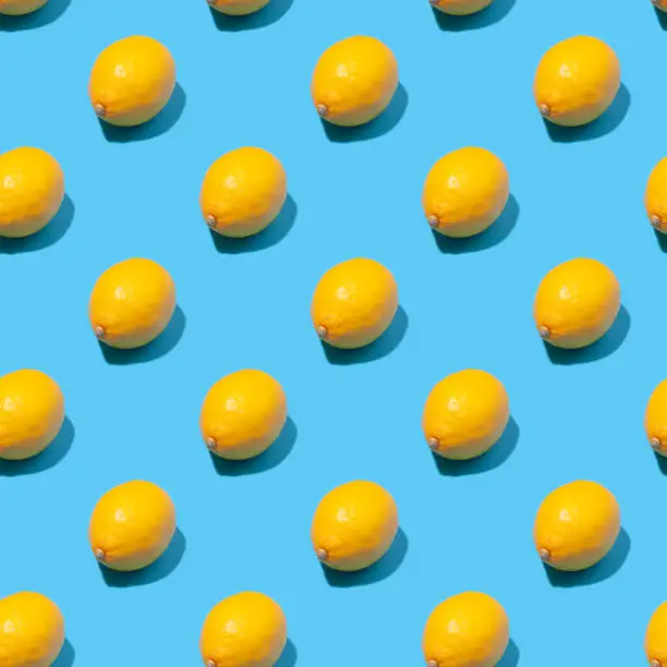 Seamless summer background with lemons - absolutely seamless pattern with yellow lemons on a blue background