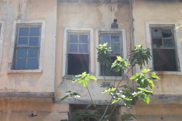 istock A ruined house with broken windows on a summer day 1422798280