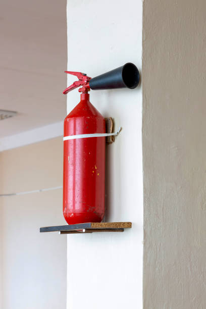 istock Portable hand-held fire extinguisher mounted on the wall inside the room 1422799508