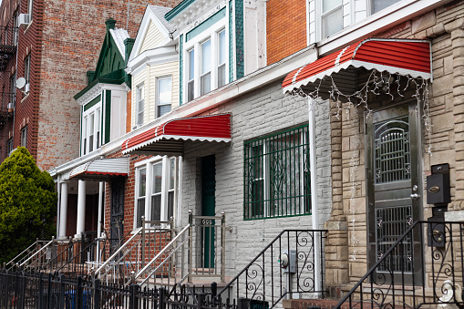 A row of the front entrances of small and colorful old homes in Midwood Brooklyn of New York City