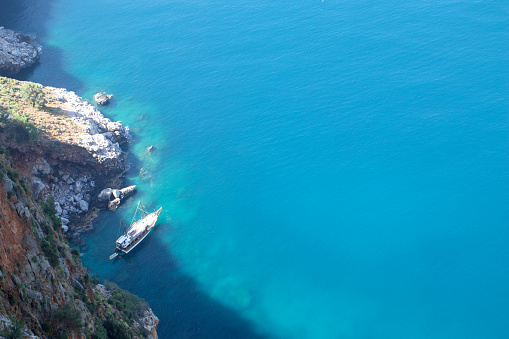 Aerial view of the cliff and the lagoon with the yacht.
