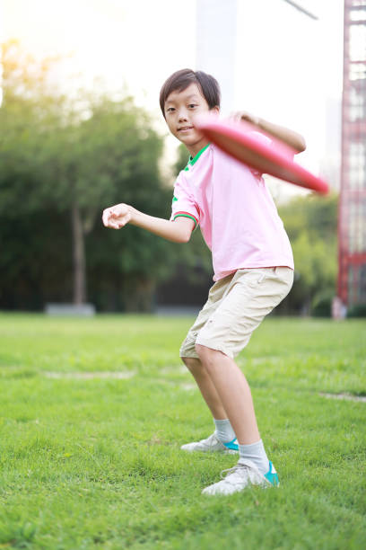istock Little boy plays frisbee in park 1422804420