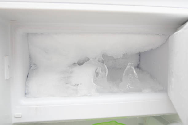 The refrigerator freezer is full of ice. Defrosting is required The refrigerator freezer is full of ice. Defrosting is required fridge frost stock pictures, royalty-free photos & images