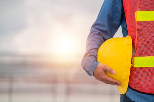 istock Engineer holding hard hat construction worker professional safety work industry building person manager service 1422806601