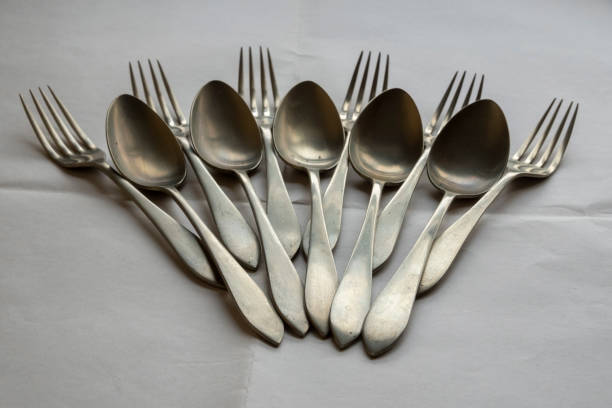 istock Forks and spoons arranged on white tablecloth 1422806925