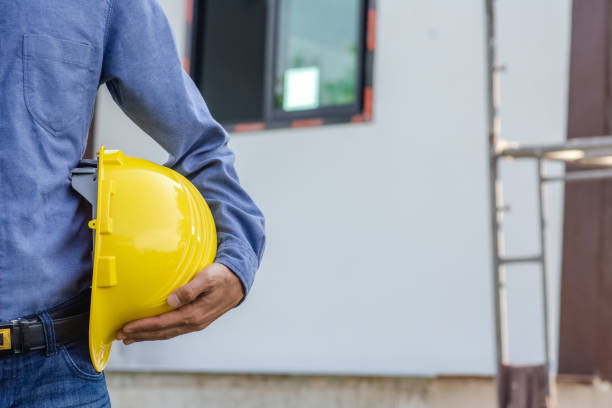 istock Engineer holding hard hat construction worker professional safety work industry building person manager service 1422807255