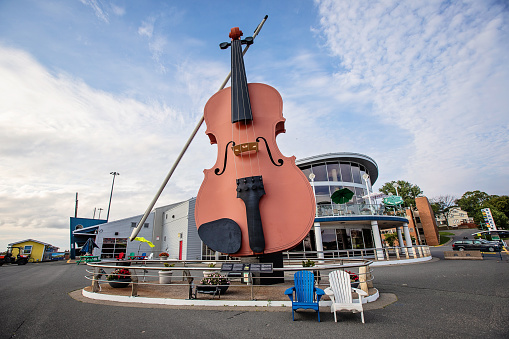 Sydney, Canada - August 26, 2022. The World's Largest Fiddle stands outside of the Sydney, Nova Scotia, cruise ship pavilion.