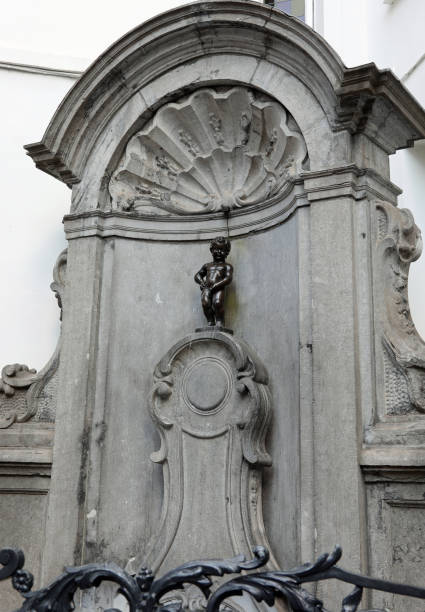 Manneken Pis is a  fountain with a statue of a pissing boy famous Brussels fountain called MANNEKEN PIS with the statue of the child peeing manneken pis statue in brussels belgium stock pictures, royalty-free photos & images