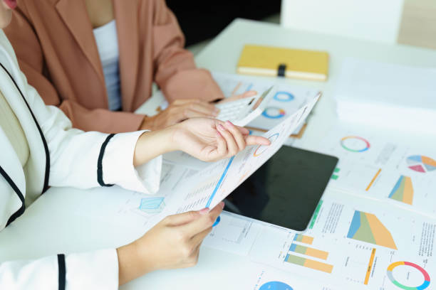istock Two Asian businesswoman using a calculator and documents to work. 1422812935