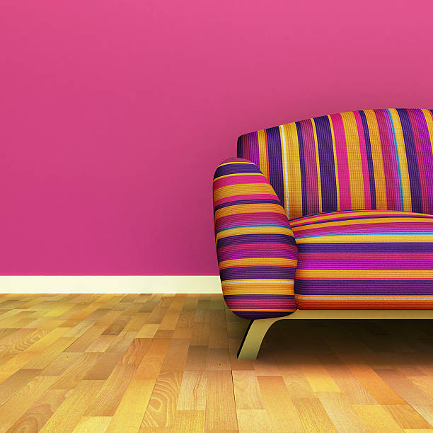 istock Room with multicolored couch, pink wall, and wood floors 142281336