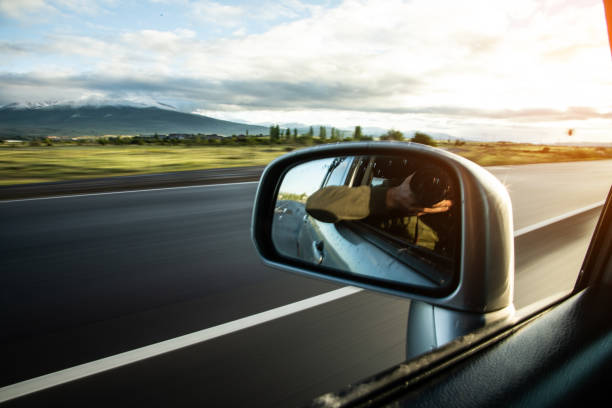 istock man takes photo in mirror in car 1422814445