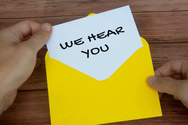 istock We hear you text on white notepad in yellow envelope. Listening concept 1422816467