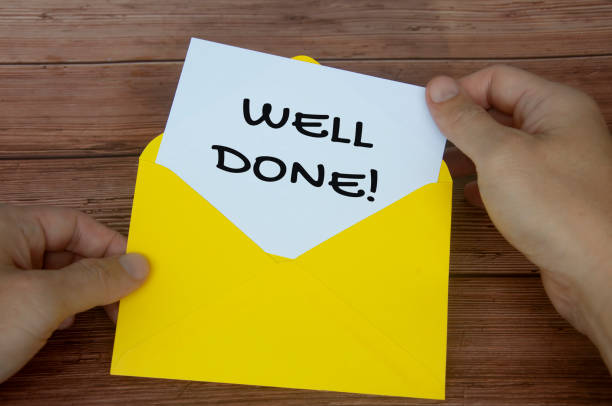 istock Well done text on white notepad with hand opening the envelope. Motivational concept 1422816476