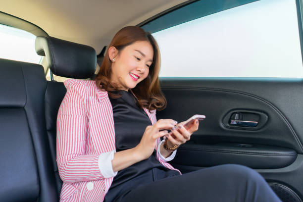 istock Asian woman talk by mobile calling on cellular phone while sitting in her car, driving under the influence,driver is safely talking by smartphone in a car concept 1422818559