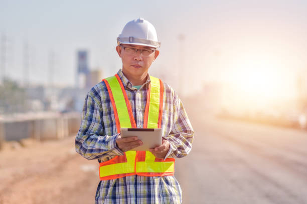istock Asian man construction safety suit helmet onsite work, Asian man Engineer 1422819627