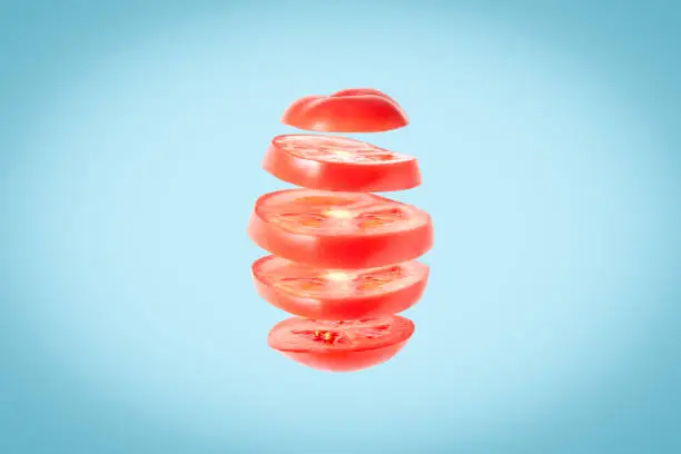 Tomato slices floating in the air - sliced tomato levitation