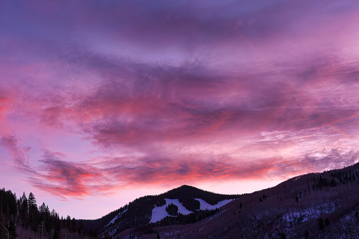 Beaver Creek Ski Resort in Early Winter - Colorful sunset skies with mountains and ski runs visible.