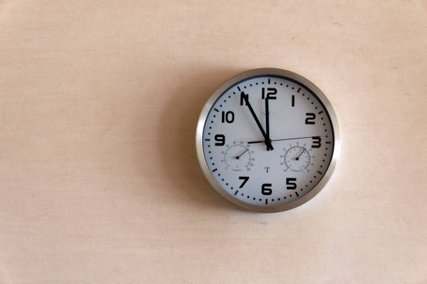 istock Clock showing five minutes to twelve 1422826634