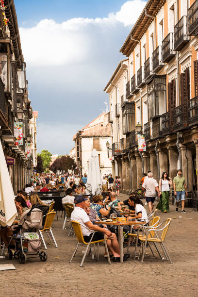 Bar tables and tourists dining along the streets of Alcala de Henares Alcala de Henares, Spain - June 18, 2022: Bar tables and tourists dining along the streets of Alcala de Henares alcala de henares stock pictures, royalty-free photos & images