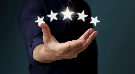 Man giving positive review for client's satisfaction surveys. Man giving a five star rating. Five star service rating. Customer evaluation feedback. Satisfaction concept.