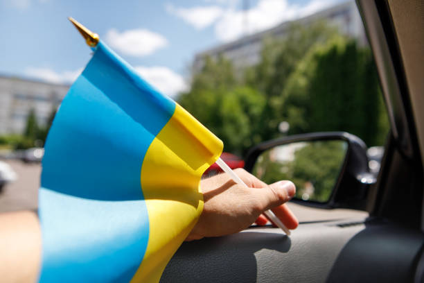 istock Ukrainian flag on glass inside the car. Stop War 1422835786