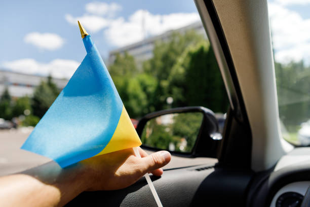 istock Ukrainian flag on glass inside the car. Stop War 1422835808