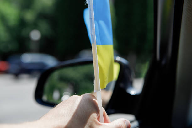 Ukrainian flag on glass inside the car. Stop War