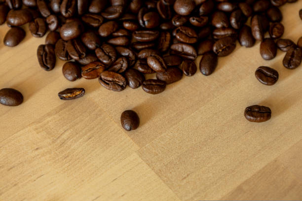 Brown Roasted Coffee Beans Closeup On Wooden Background. High quality photo