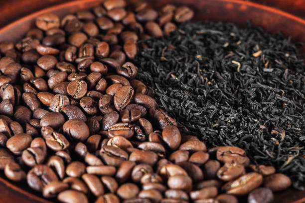 istock coffee vs. tea isometric projection. tea or coffee? choice of drink concept. coffee beans and natural black tea side view. selective focus 1422843019