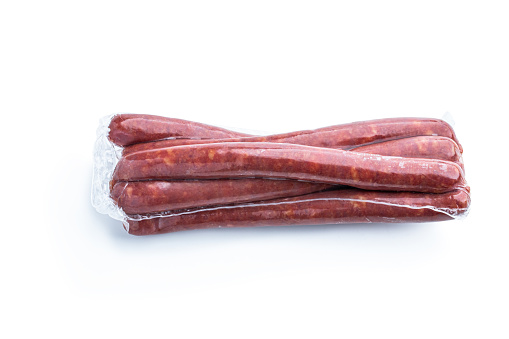 Smoked  pork thin sausages in vacuum pack isolated on white