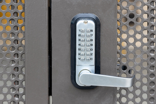 Man is closing or opening the door lock from the inside. Security and protection against robbers concept.