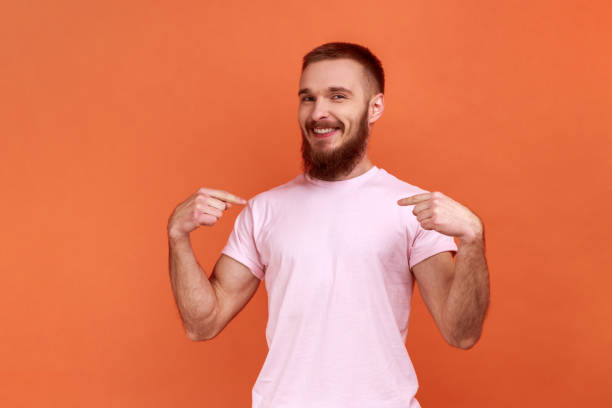 istock Man with toothy smile on face pointing fingers on himself, confident positive guy. 1422843708