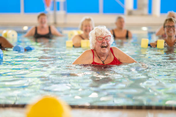 istock Senior Woman Laughing in a Pool 1422845004