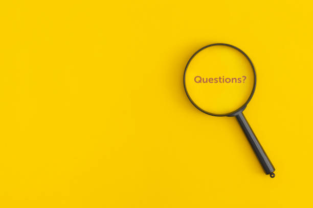 istock Magnifying glass with the word Questions on a yellow background 1422845252