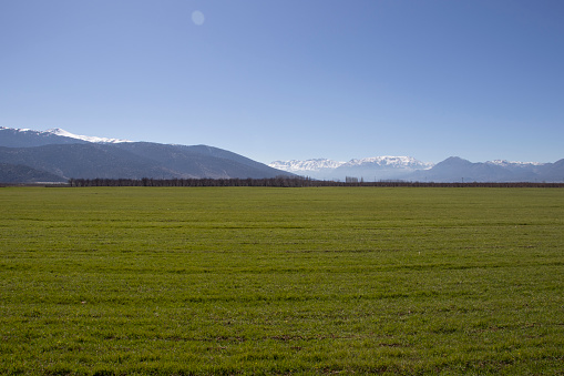 GREEN FIELDS, MOUNTAINS BEHIND AND AN EXCELLENT VIEW