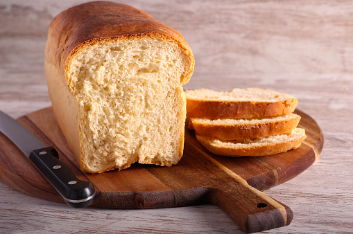 Country white bread, homemade loaf of white bread, sliced on board