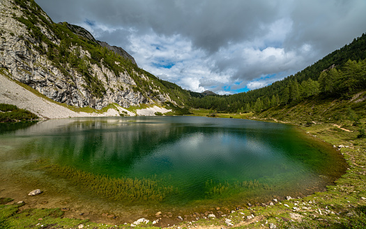 Beautiful panorama view of Schwarzensee lake near Tauplitzalm in Ausseerland region on a sunny summer day with blue sky cloud, Styria, Austria