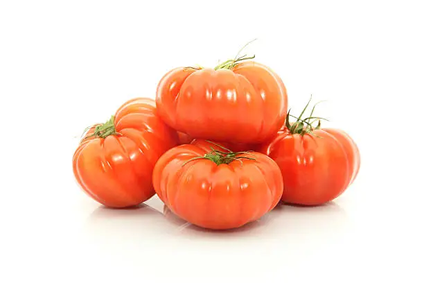 details of beefsteak tomatoes isolated on white