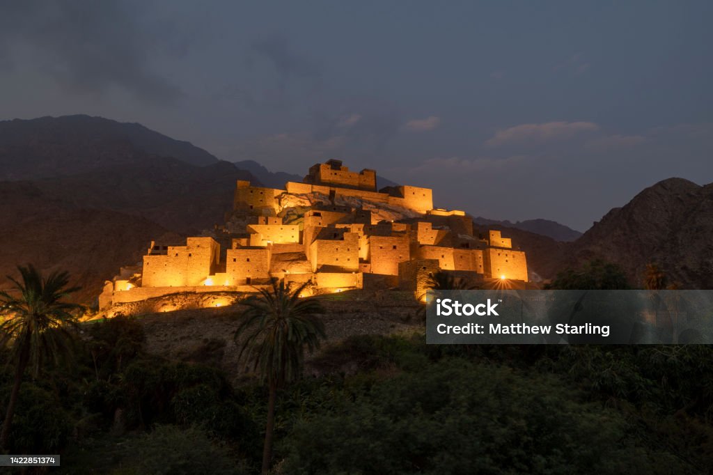 Panoramic view of Thee Ain (Dhee Ayn) heritage village in the Al-Baha region of Saudi Arabia The village of Thee Ain is in the Al-Mikhwat province of the Al-Baha Region, Saudi Arabia. The village is characterized by houses built from polished stones. Ancient Stock Photo