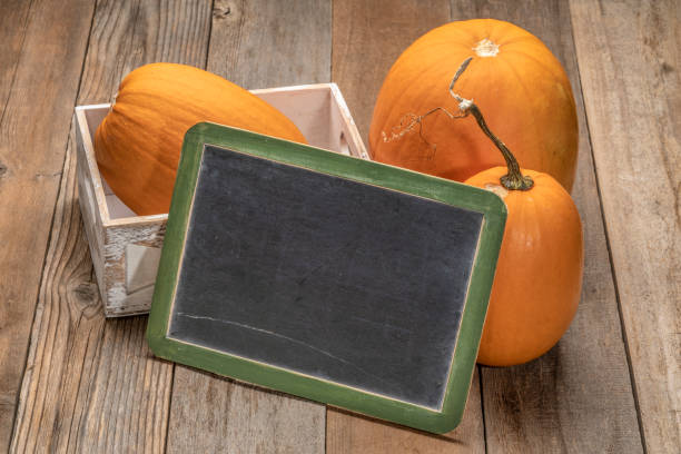 istock Blank slate blackboard with pumpkins 1422851387