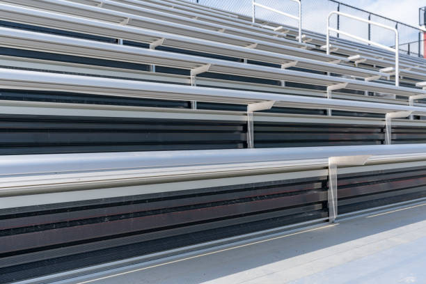 Close-Up of empty metal stadium bleacher bench seats.	 Nondescript location with no people in image.  Not a ticketed event. Close-Up of empty metal stadium bleacher bench seats.	 Nondescript location with no people in image.  Not a ticketed event. school bleachers stock pictures, royalty-free photos & images