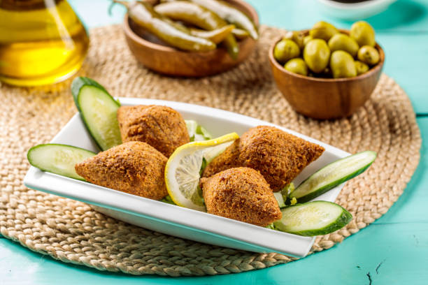 istock Kebbah with lemon slice and olive served in a dish isolated on wooden table side view of middle eastern food 1422852892