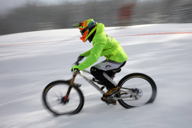 Sofia, Bulgaria - 22 January, 2022: Cyclist rides a bike downhill during an extreme snow riding mountain bicycle competition in Vitosha mountain.