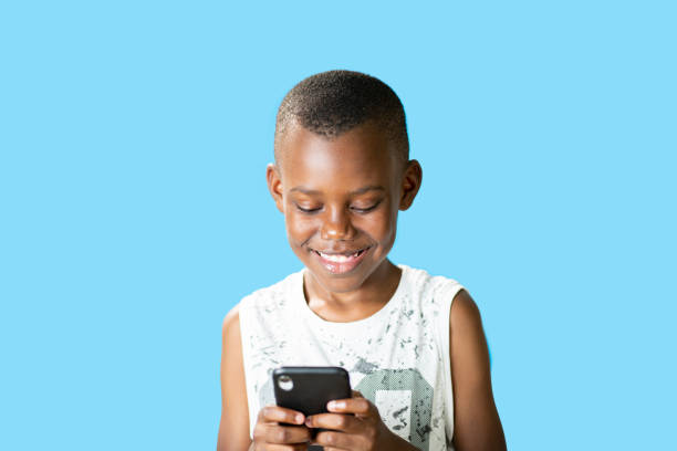 istock young black guy uses smartphone smiling and isolated on blue background 1422854886