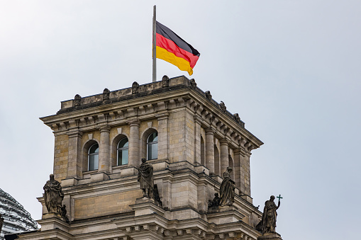 The federal flag in front of the Reichstag worth seeing in Berlin, Germany